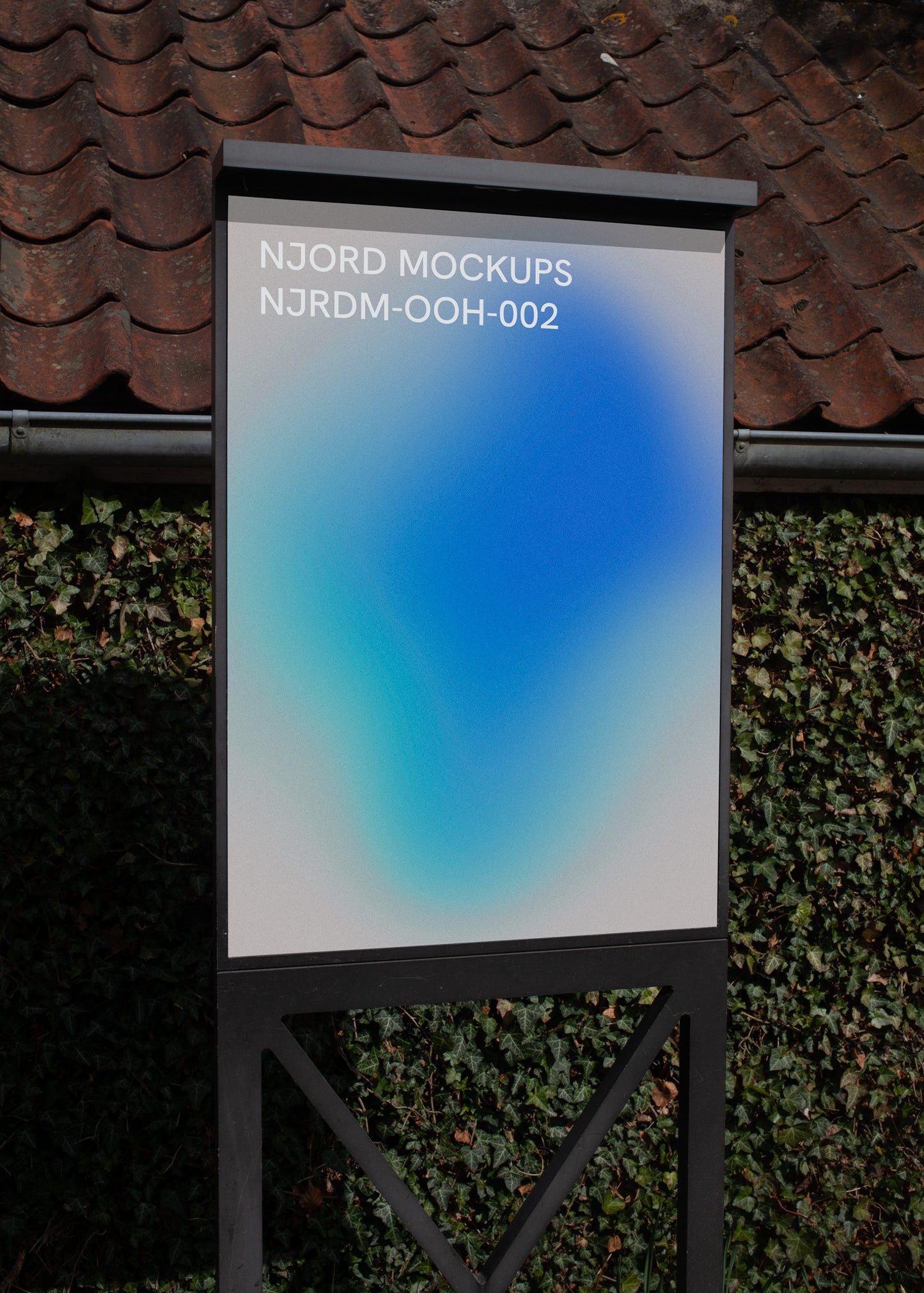 A-frame poster mockup with sample design outside the Louisiana Museum of Modern Art in Denmark, with greenery in the background